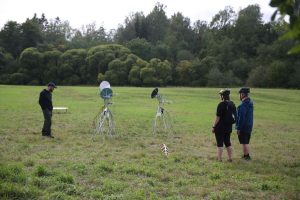 Installation view of two, solar powered, moving sculptures Heliotropes, and the target sculpture Gatherer, Pitkäkoski meadow, 2024