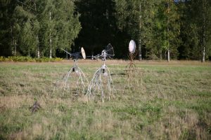 Installation view of two, solar powered, moving sculptures Heliotropes, and the target sculpture Gatherer, Pitkäkoski meadow, 2024