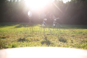 Installation view of two, solar powered, moving sculptures Heliotropes, and the target sculpture Gatherer, Pitkäkoski meadow, 2024