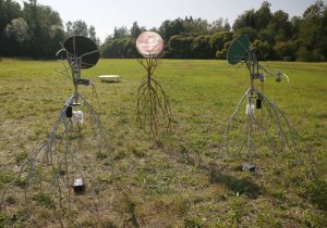 Installation view of two, solar powered, moving sculptures Heliotropes, and the target sculpture Gatherer.